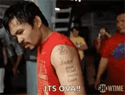 A Man With A Tattoo On His Arm Is Standing In A Gym And Says `` It 'S Ova '' . GIF