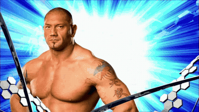 A Man With A Tattoo On His Arm Is Standing In Front Of A Blue Background GIF