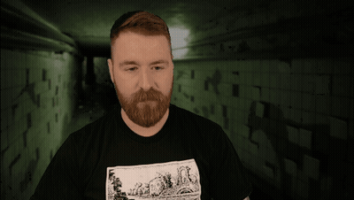 A Man With A Tattoo On His Arm Is Wearing A Black Shirt With A Picture Of A Sheep On It GIF
