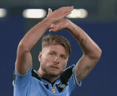 A Man With A Tattoo On His Arm Is Wearing A Blue Shirt With The Word Jeep On It GIF