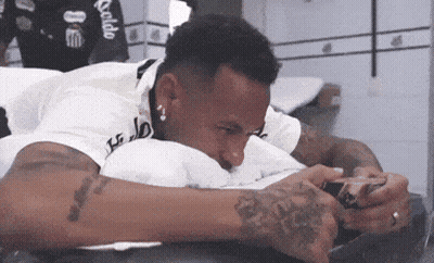 A Man With A Tattoo On His Arm Laying On A Bed GIF