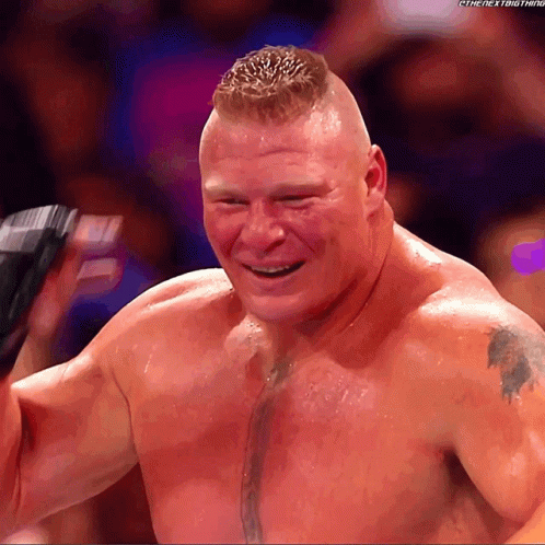 A Man With A Tattoo On His Chest Is Smiling In Front Of A Crowd GIF