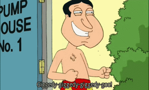 A Man With A Tattoo On His Chest Is Standing In Front Of A Pump House GIF