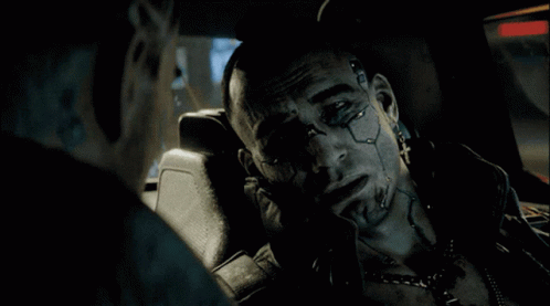 A Man With A Tattoo On His Face Is Sitting In A Car With Another Man GIF