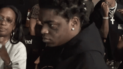 A Man With A Tattoo On His Face Is Sitting Next To A Woman Wearing A Sweatshirt That Says Astroworld GIF