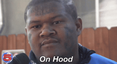 A Man With A Tattoo On His Face Is Wearing A Blue Shirt That Says On Hood GIF