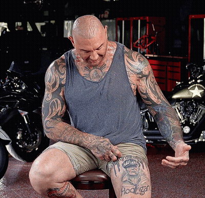 A Man With A Tattoo On His Leg That Says ' Hoonigan ' GIF