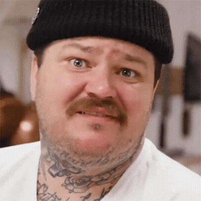 A Man With A Tattoo On His Neck Is Wearing A Beanie GIF