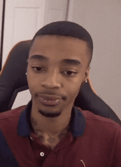 A Man With A Tattoo On His Neck Is Wearing A Maroon Shirt GIF