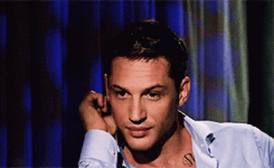 A Man With A Tattoo On His Neck Looks To The Side GIF