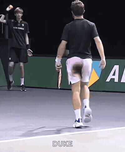 A Man With A Tennis Racquet Is Running On A Tennis Court And The Word Duke Is On The Bottom GIF