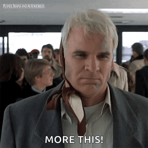 A Man With A Tie On His Head Says " More This " GIF