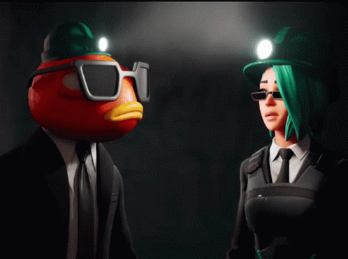 A Man With A Tomato Head And A Woman With Green Hair Standing Next To Each Other GIF