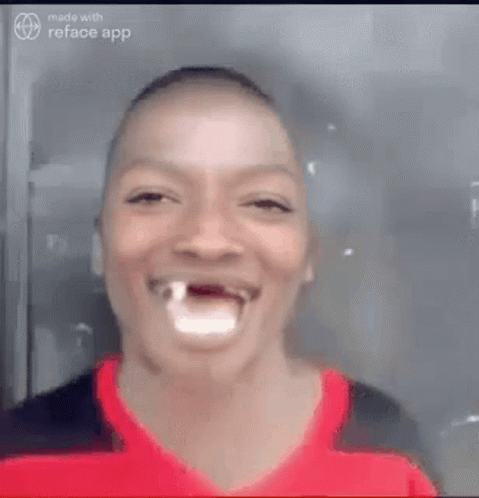 A Man With A Tooth Missing Is Laughing And Smiling . GIF