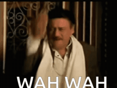 A Man With A Towel Around His Neck And The Words Wah Wah Written Below Him GIF