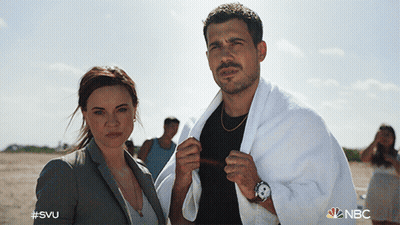 A Man With A Towel Around His Neck Stands Next To A Woman With #Svu On The Bottom GIF