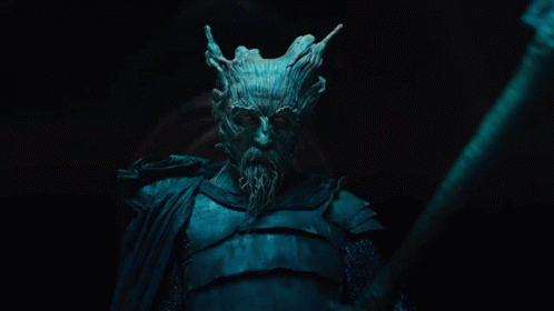 A Man With A Tree Face And A Beard Is Holding A Large Axe GIF