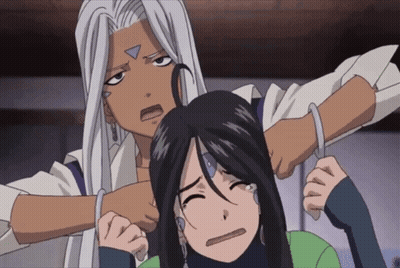 A Man With A Triangle On His Face Is Holding A Woman 'S Head GIF