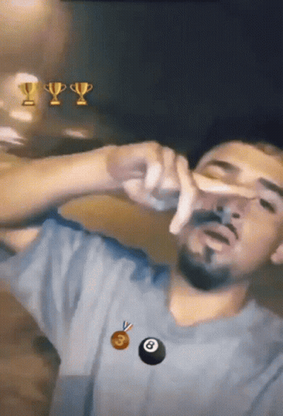 A Man With A Trophy And A Pool Ball In The Background GIF