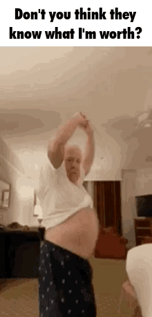 A Man With A Very Large Belly Is Dancing In A Living Room With His Arms In The Air . GIF