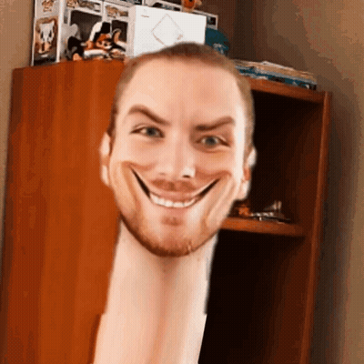 A Man With A Very Long Neck Is Smiling In Front Of A Bookshelf . GIF