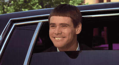 A Man With A Very Short Haircut Is Smiling While Looking Out Of A Car Window GIF