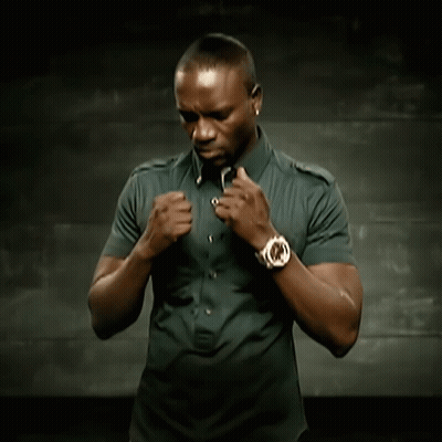 A Man With A Watch On His Wrist Is Adjusting His Shirt GIF