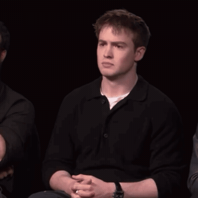 A Man With A Watch On His Wrist Is Laughing With His Mouth Open GIF