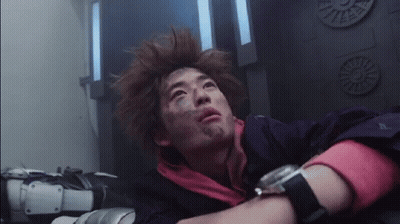 A Man With A Watch On His Wrist Is Laying Down In A Room . GIF