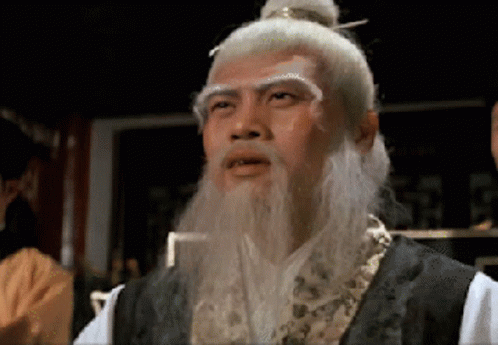 A Man With A White Beard And A Bun On His Head GIF
