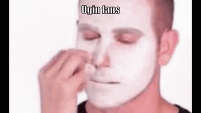 A Man With A White Face Is Cleaning His Nose . GIF