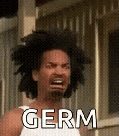 A Man With A White Tank Top Is Making A Funny Face And Saying Germ . GIF