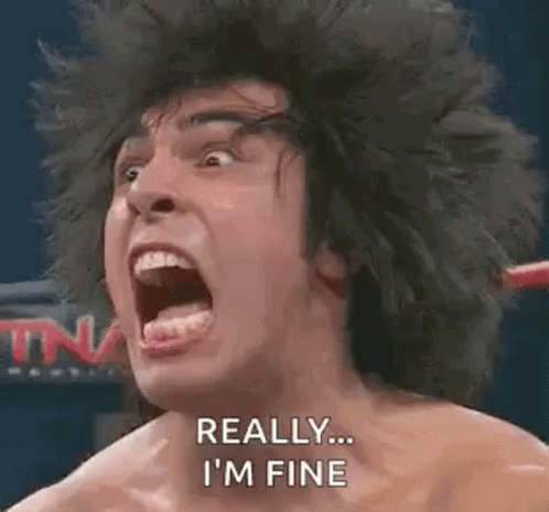 A Man With A Wig On Is Screaming In A Boxing Ring With His Mouth Open . GIF