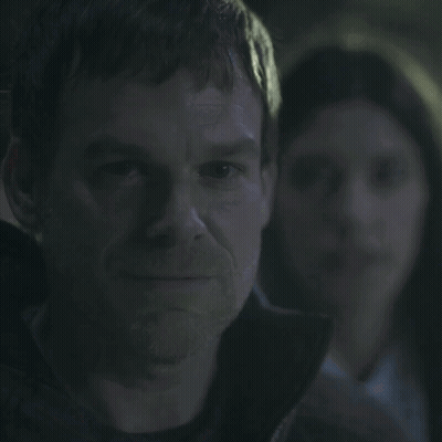 A Man With A Woman In The Background And The Words You Smug Fuck GIF