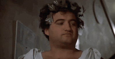 A Man With A Wreath Of Leaves On His Head Says Sorry GIF