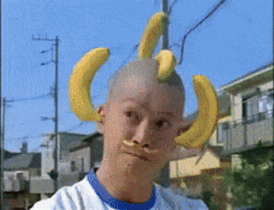 A Man With Bananas On His Head And A Fake Mustache GIF