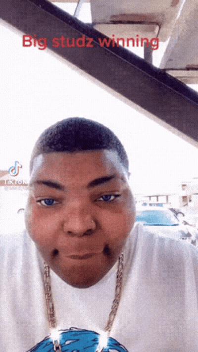 A Man With Big Studz Winning Written On The Top Of His Head GIF