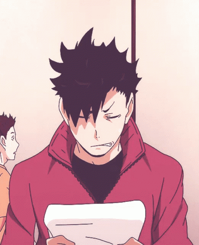 A Man With Black Hair Is Holding A Piece Of Paper In His Hand GIF