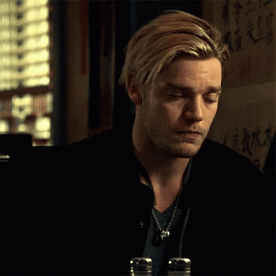 A Man With Blonde Hair And A Beard Is Sitting At A Table With Salt And Pepper Shakers In Front Of Him . GIF