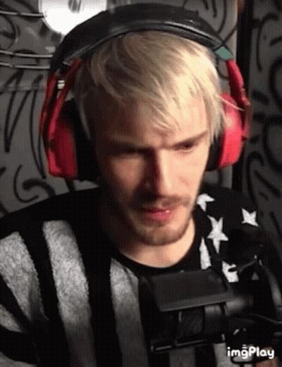 A Man With Blonde Hair And A Beard Wearing Headphones GIF
