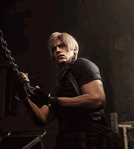 A Man With Blonde Hair And A Black Shirt Is Holding A Chain GIF