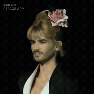 A Man With Blonde Hair And A Pink Rose In His Hair Is Made With Reface App GIF
