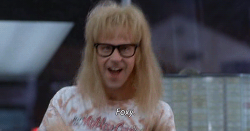 A Man With Blonde Hair And Glasses Is Wearing A T-Shirt That Says Foxy GIF