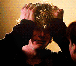 A Man With Blonde Hair Is Holding His Hands To His Head And Crying GIF