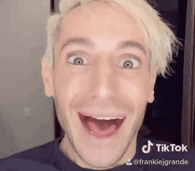 A Man With Blonde Hair Is Making A Funny Face . GIF