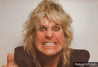 A Man With Blonde Hair Is Making A Very Angry Face . GIF