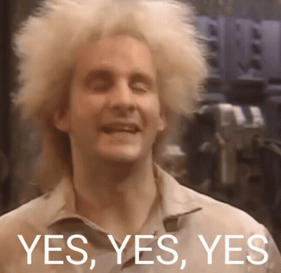A Man With Blonde Hair Is Smiling With The Words Yes Yes Yes Behind Him GIF