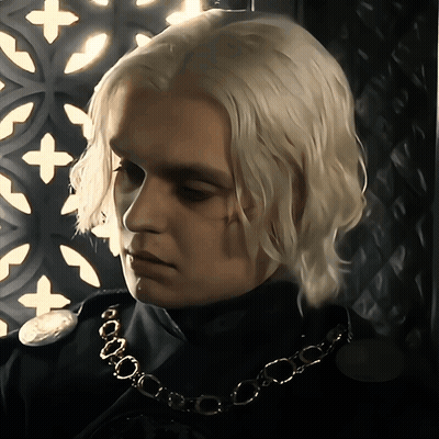A Man With Blonde Hair Is Wearing A Necklace GIF