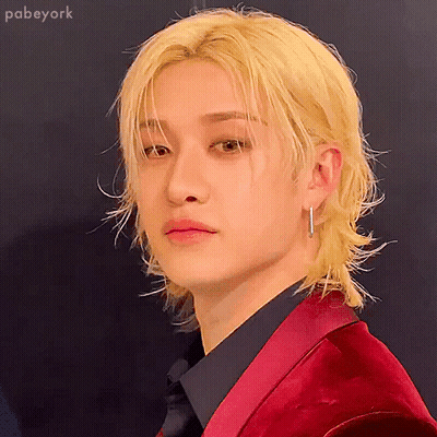A Man With Blonde Hair Is Wearing A Red Jacket GIF