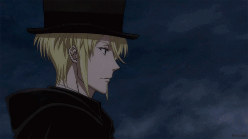 A Man With Blonde Hair Wearing A Top Hat And A Cape GIF